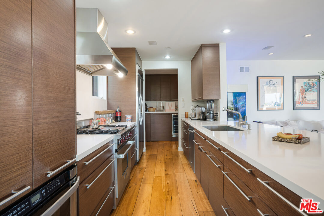 245 Tranquillo Road Pacific Palisades, CA 90272 - Photo 21 of 45 a kitchen with stainless steel appliances a sink stove and cabinets