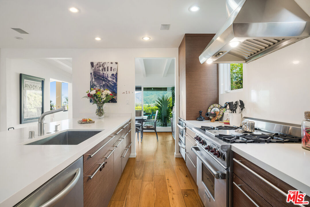 245 Tranquillo Road Pacific Palisades, CA 90272 - Photo 22 of 45 a kitchen with stove a sink and a refrigerator