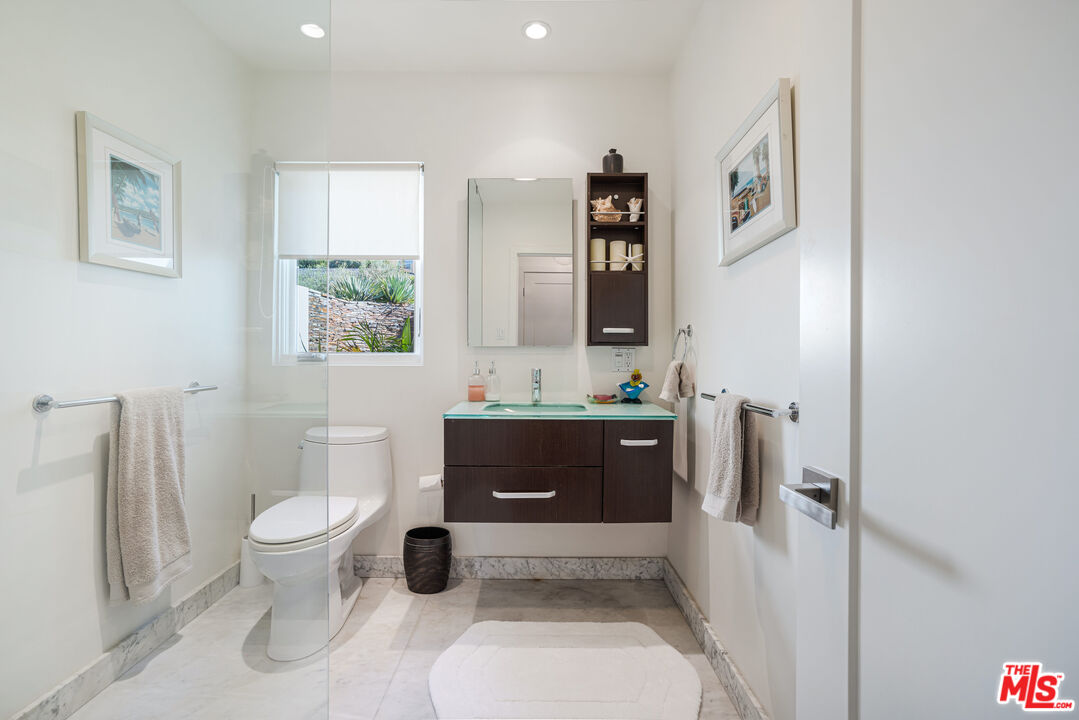 245 Tranquillo Road Pacific Palisades, CA 90272 - Photo 25 of 45 a bathroom with a toilet a sink and a mirror