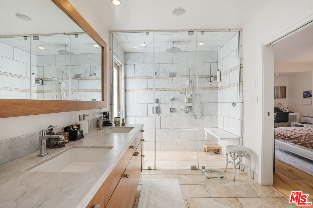 245 Tranquillo Road Pacific Palisades, CA 90272 - Photo 27 of 45 a bathroom with a tub sink and glass door shower
