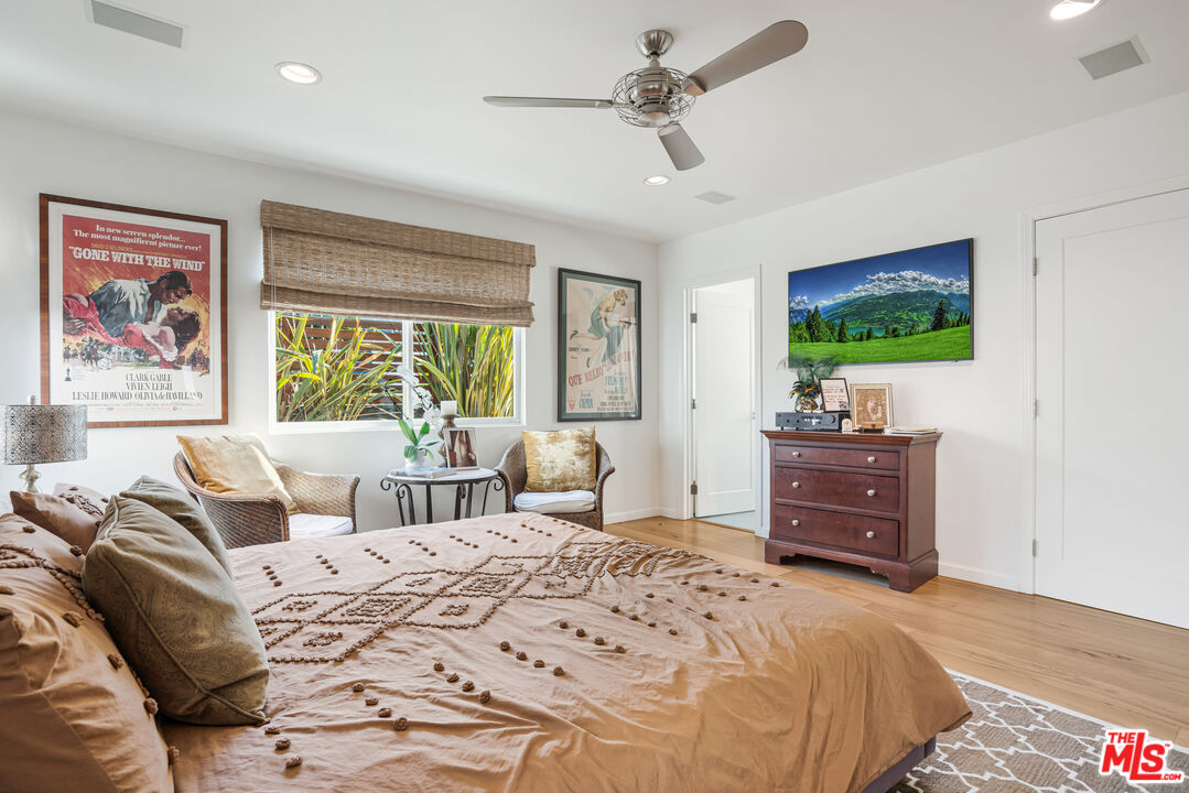 245 Tranquillo Road Pacific Palisades, CA 90272 - Photo 30 of 45 a bedroom with furniture and a flat screen tv