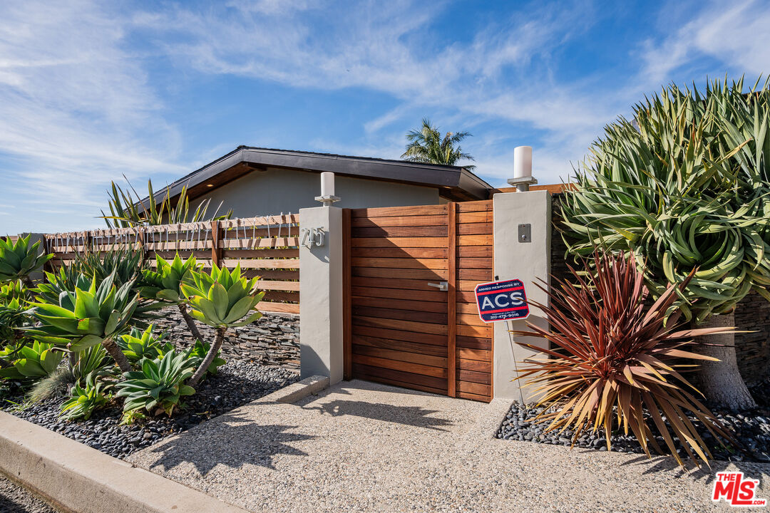 245 Tranquillo Road Pacific Palisades, CA 90272 - Photo 3 of 45 a front view of a house with a yard and plant in front of it