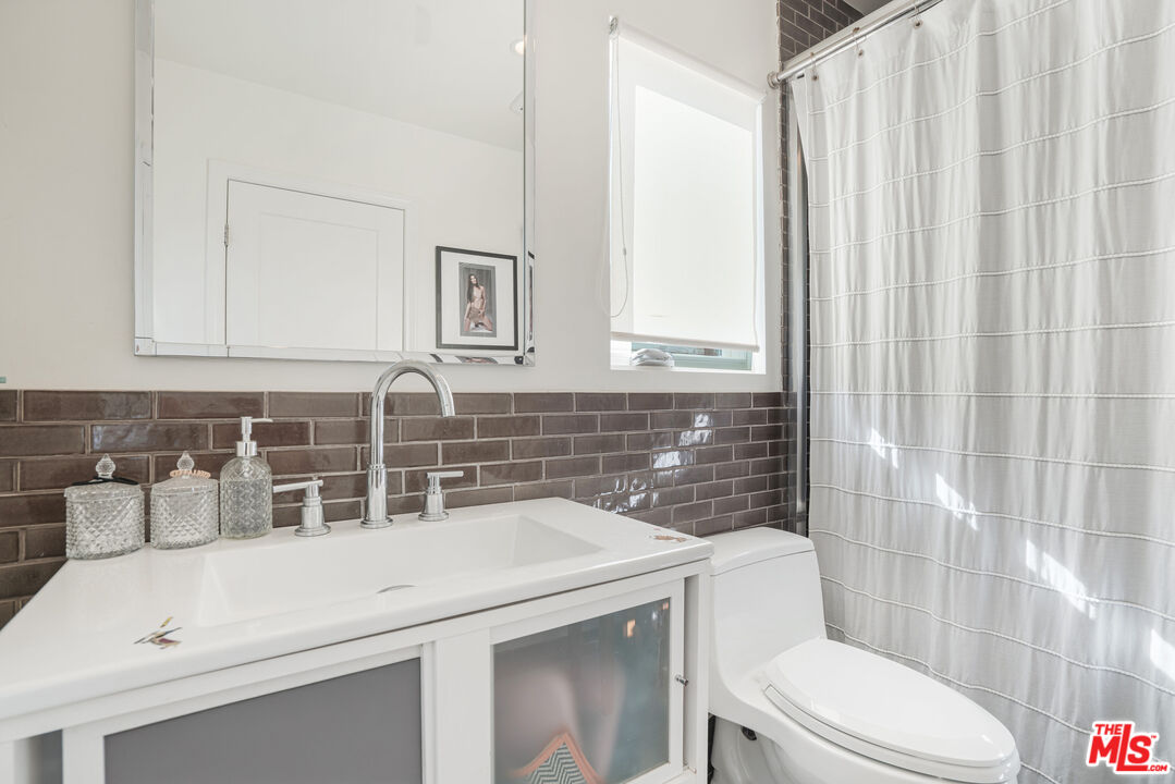 245 Tranquillo Road Pacific Palisades, CA 90272 - Photo 31 of 45 a bathroom with a sink a toilet and shower