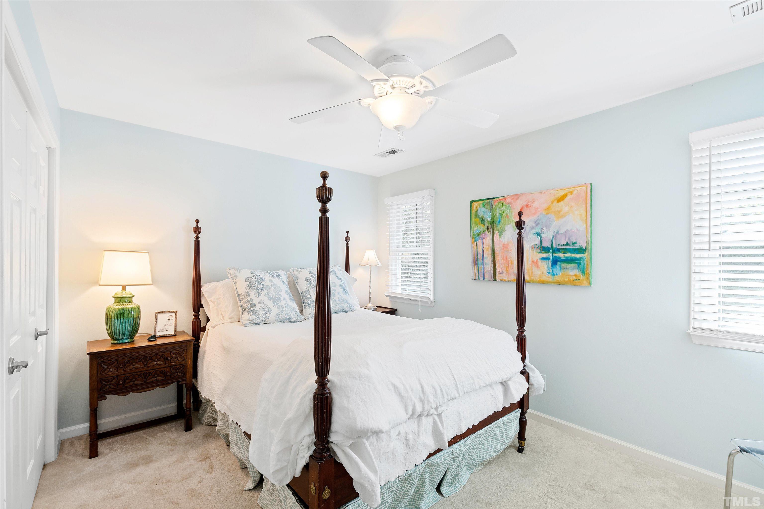2526 Noble Road Raleigh, NC 27608 - Photo 16 of 27 a bedroom with a bed chandelier and a window