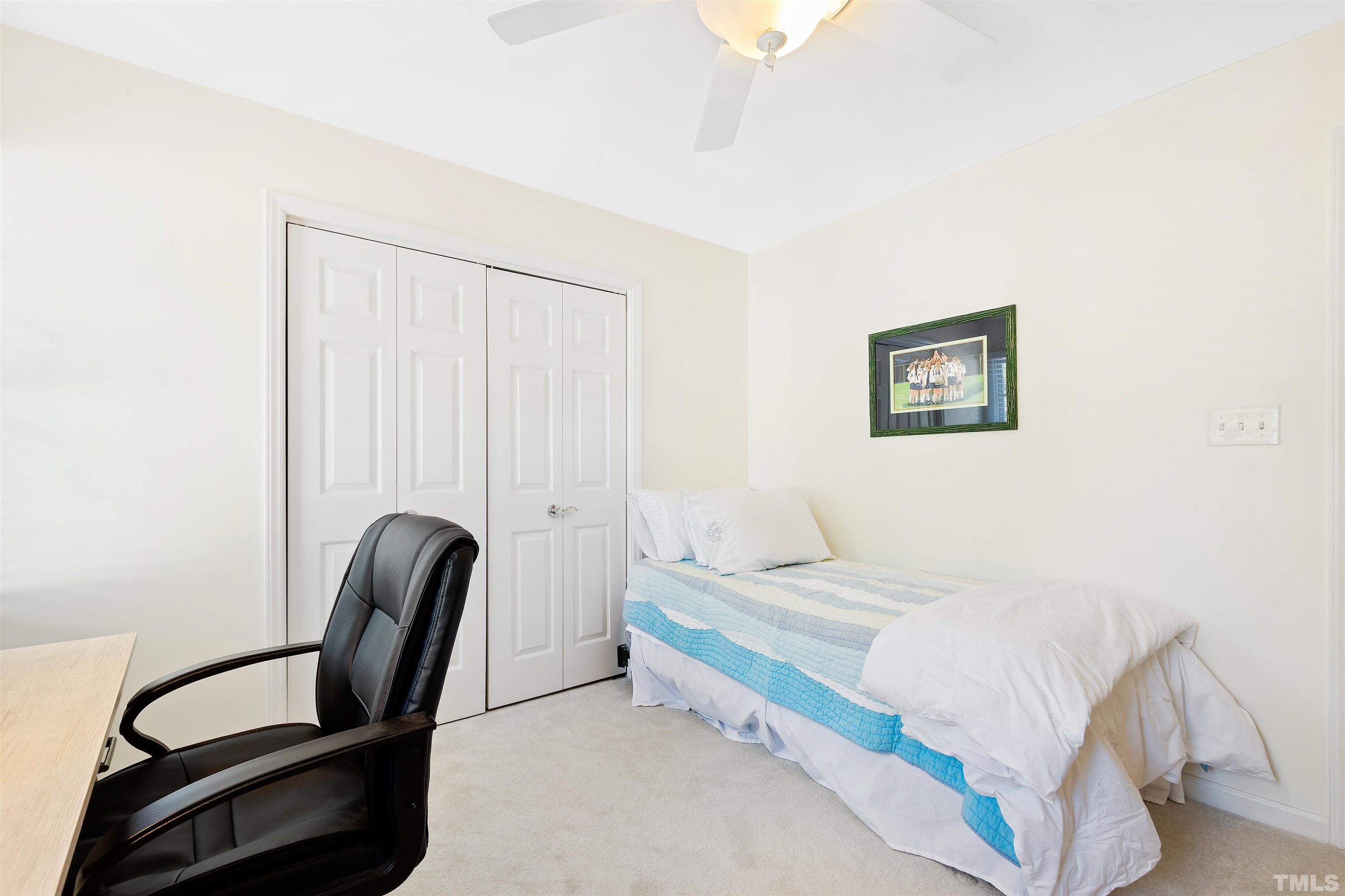 2526 Noble Road Raleigh, NC 27608 - Photo 19 of 27 a bedroom with a bed chair and a desk