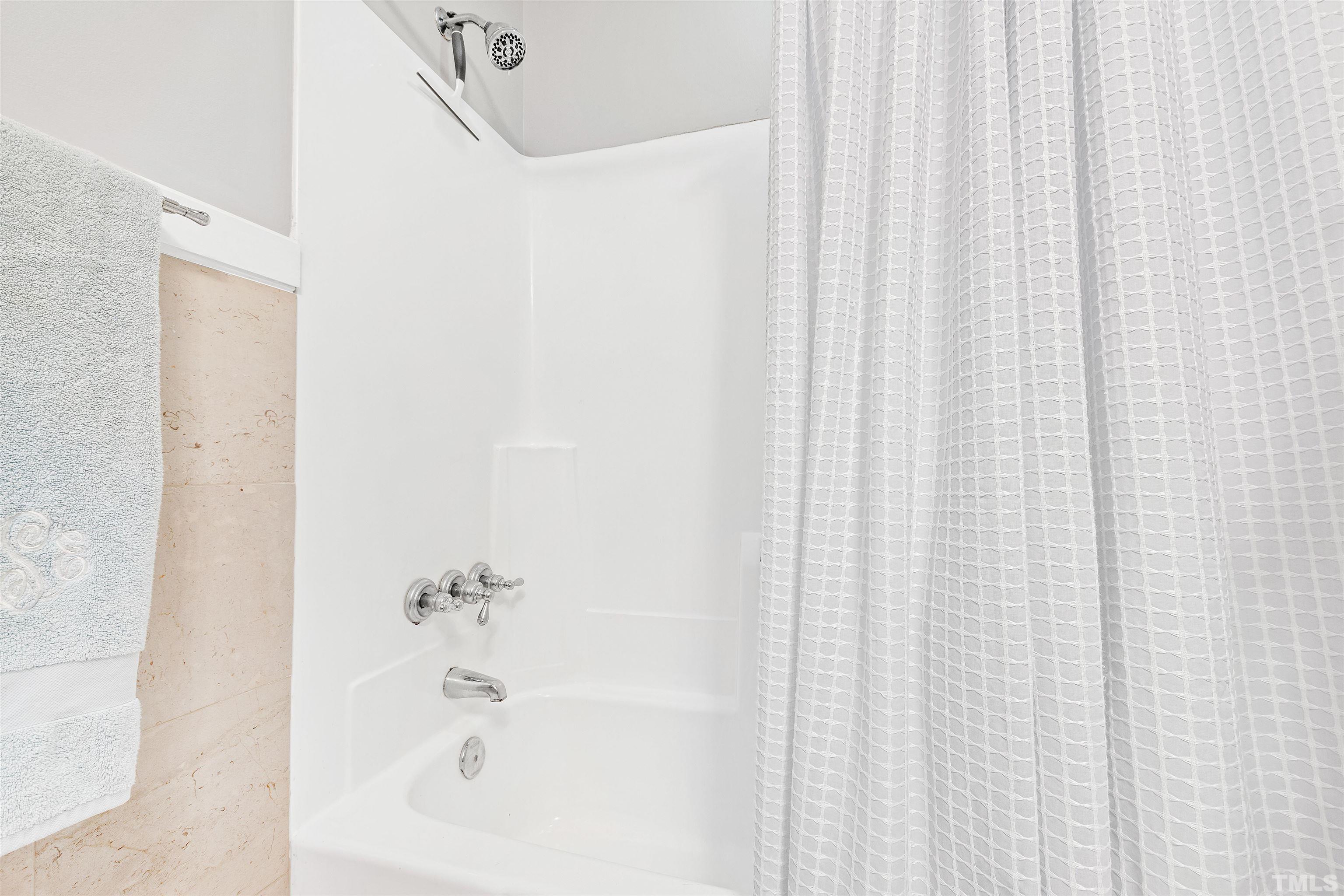 2526 Noble Road Raleigh, NC 27608 - Photo 21 of 27 a bathroom with a bathtub and shower