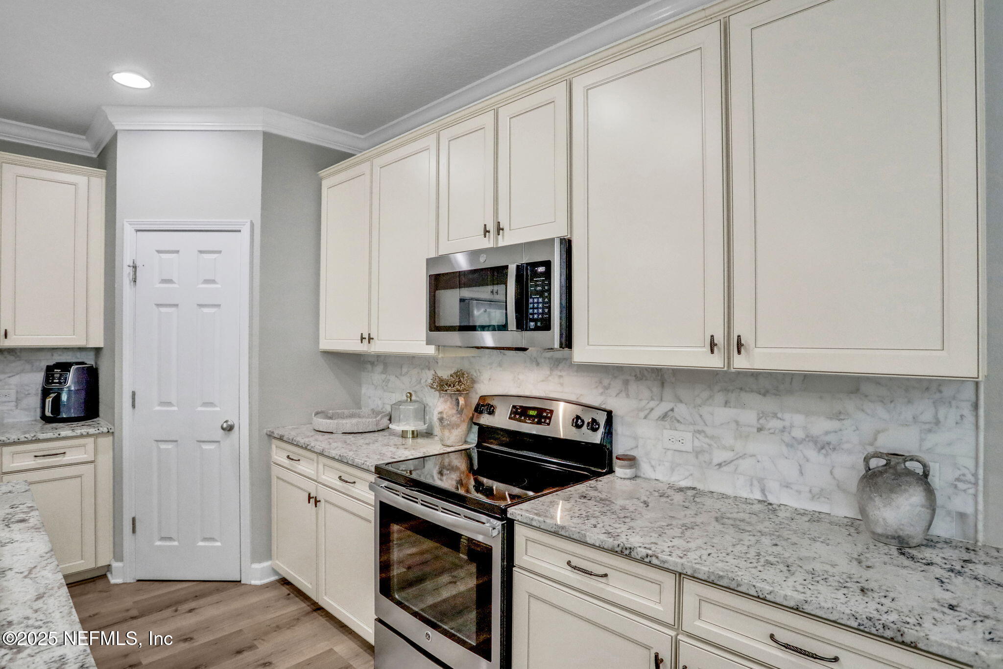 119 Duck Pond Drive St. Augustine, FL 32086 - Photo 15 of 56 a kitchen with white cabinets and appliances