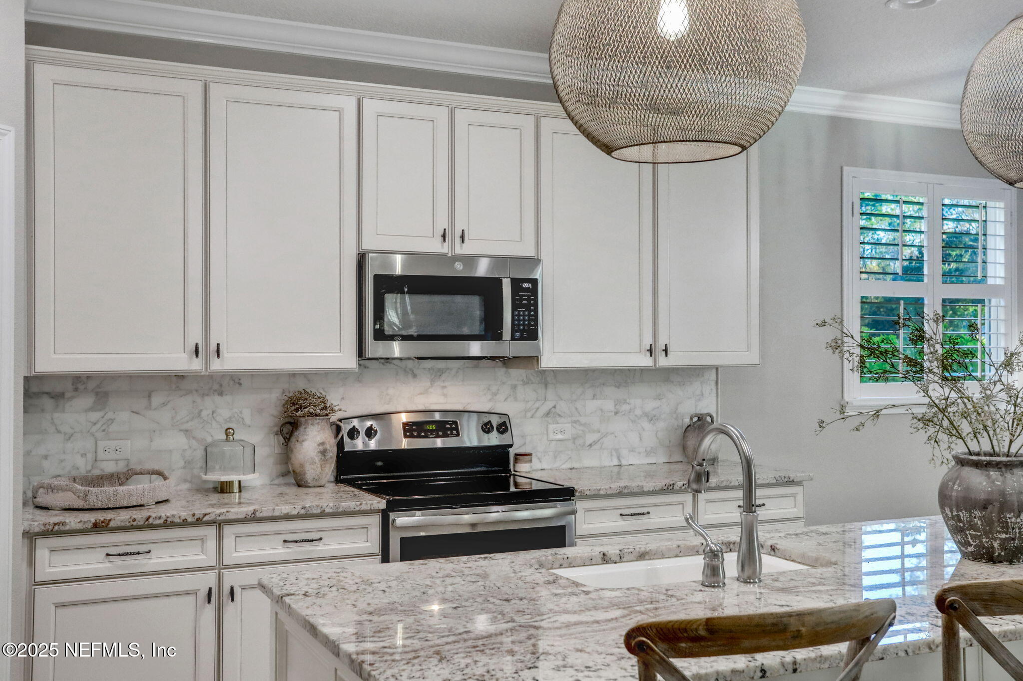 119 Duck Pond Drive St. Augustine, FL 32086 - Photo 16 of 56 a kitchen with stainless steel appliances granite countertop a stove a sink and a white cabinets