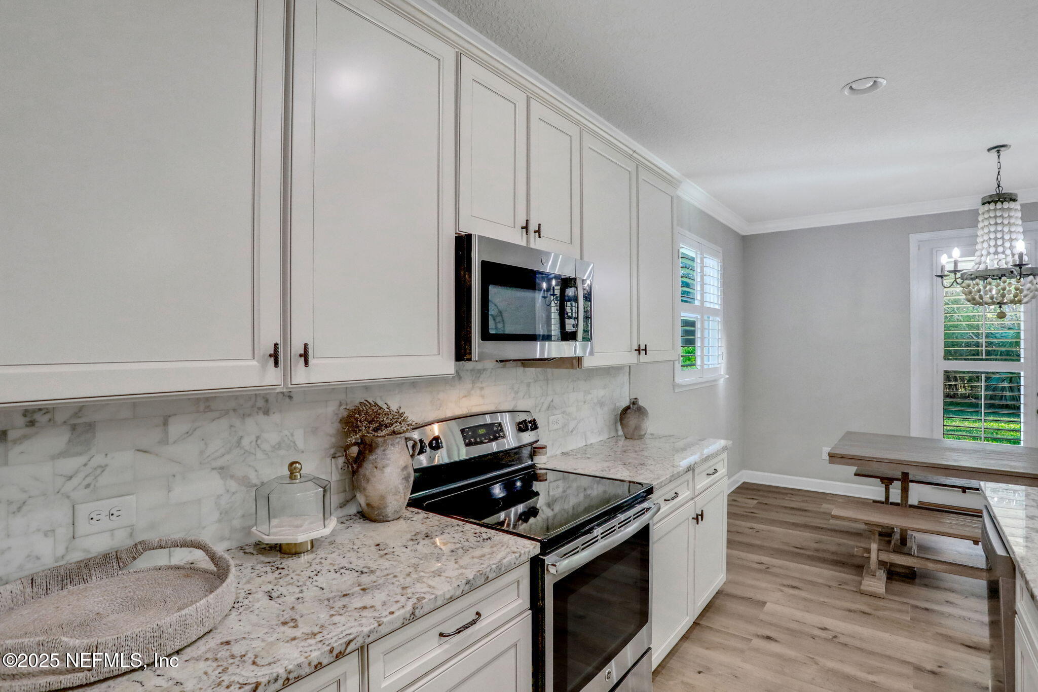 119 Duck Pond Drive St. Augustine, FL 32086 - Photo 17 of 56 a kitchen with granite countertop a stove a sink and a microwave