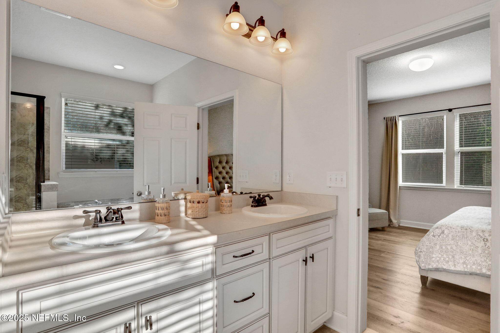 119 Duck Pond Drive St. Augustine, FL 32086 - Photo 26 of 56 a spacious bathroom with double vanity sinks a vanity lamp and a mirror