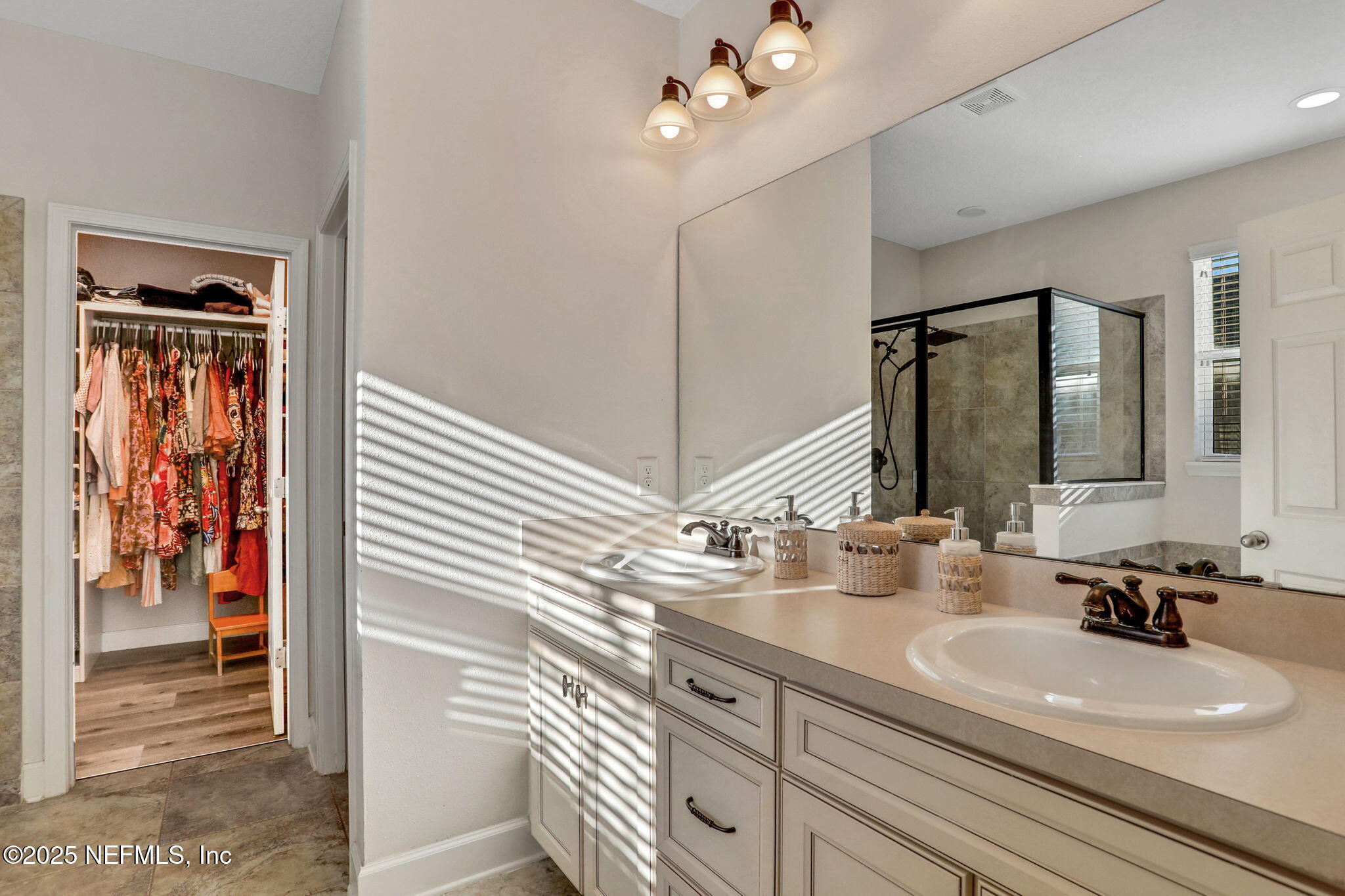 119 Duck Pond Drive St. Augustine, FL 32086 - Photo 28 of 56 a bathroom with a double vanity sink and a mirror