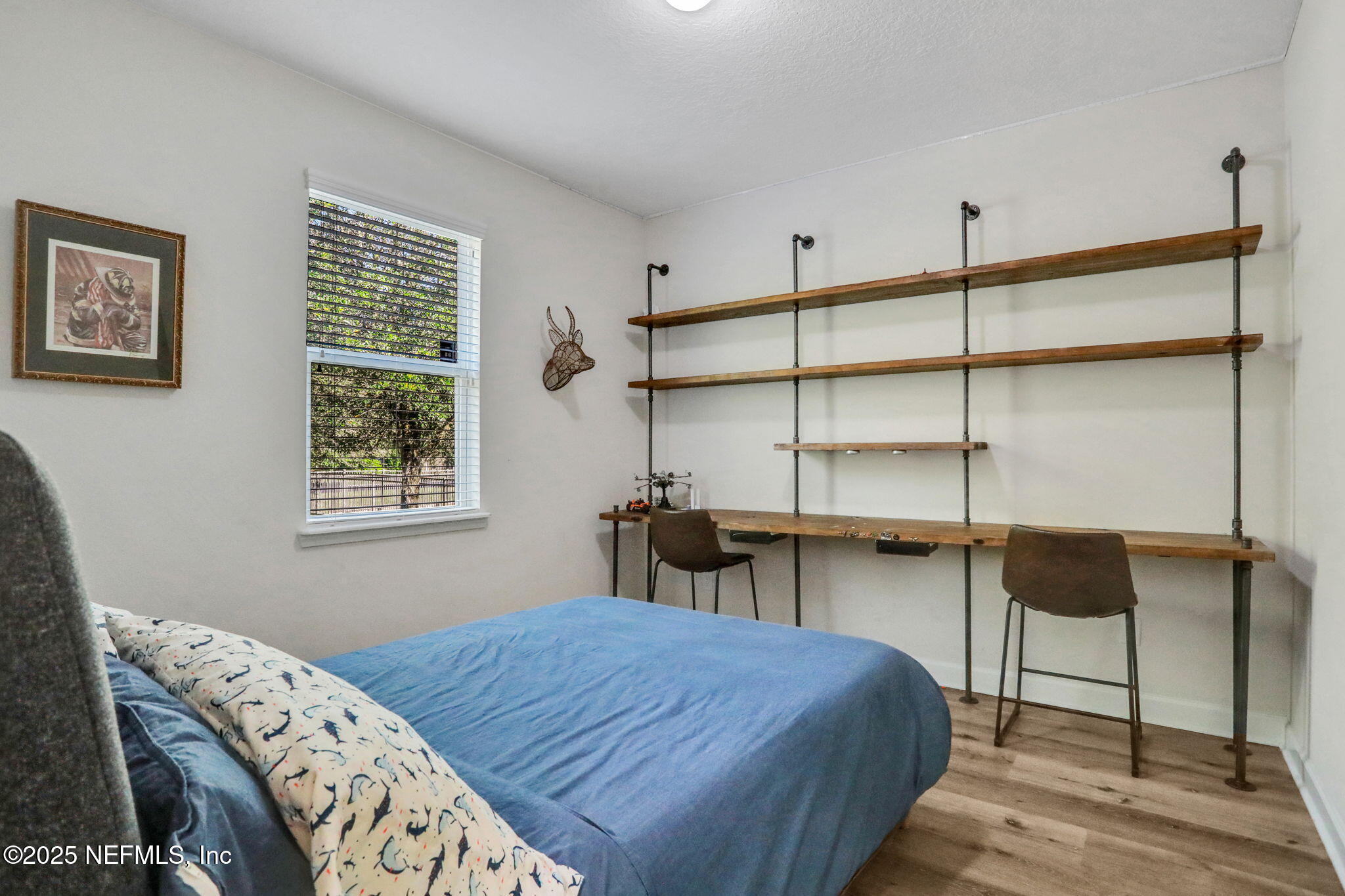 119 Duck Pond Drive St. Augustine, FL 32086 - Photo 35 of 56 a bedroom with a bed and a table in it