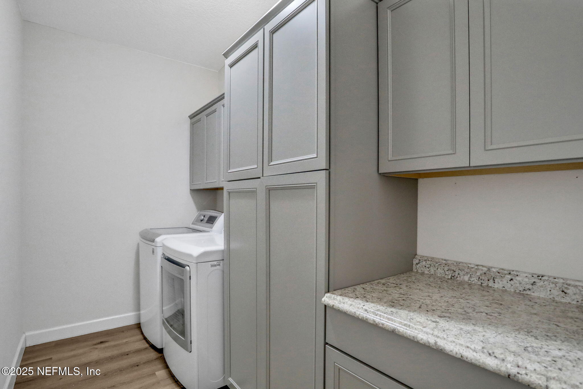 119 Duck Pond Drive St. Augustine, FL 32086 - Photo 37 of 56 a utility room with granite countertop a sink a washer and dryer