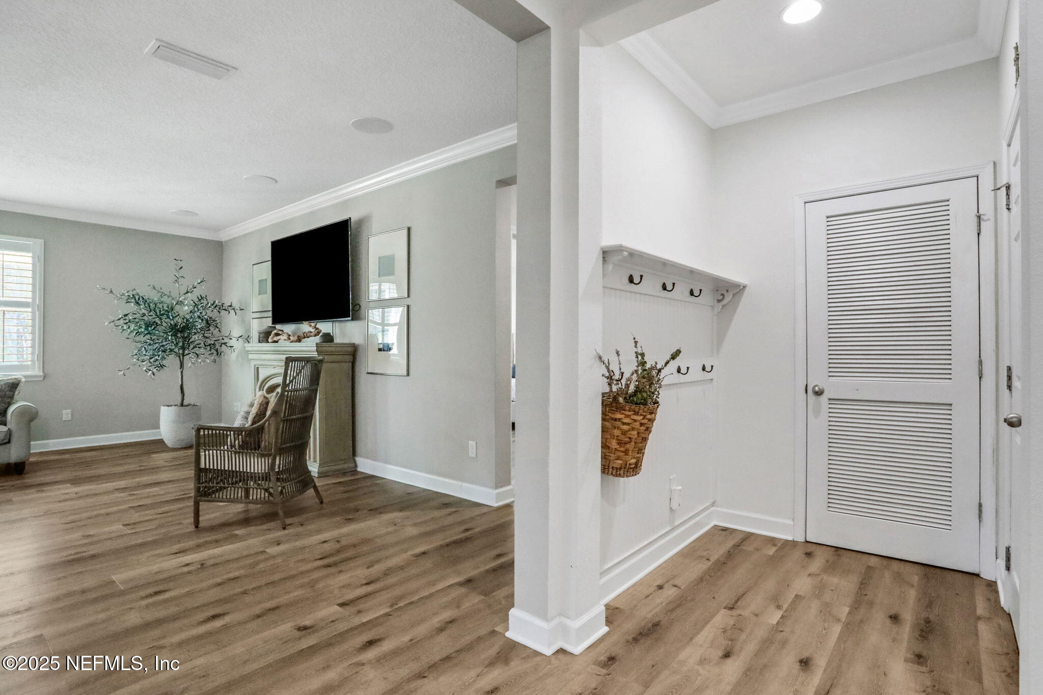 119 Duck Pond Drive St. Augustine, FL 32086 - Photo 4 of 56 a view of a livingroom with wooden floor and a flat screen tv