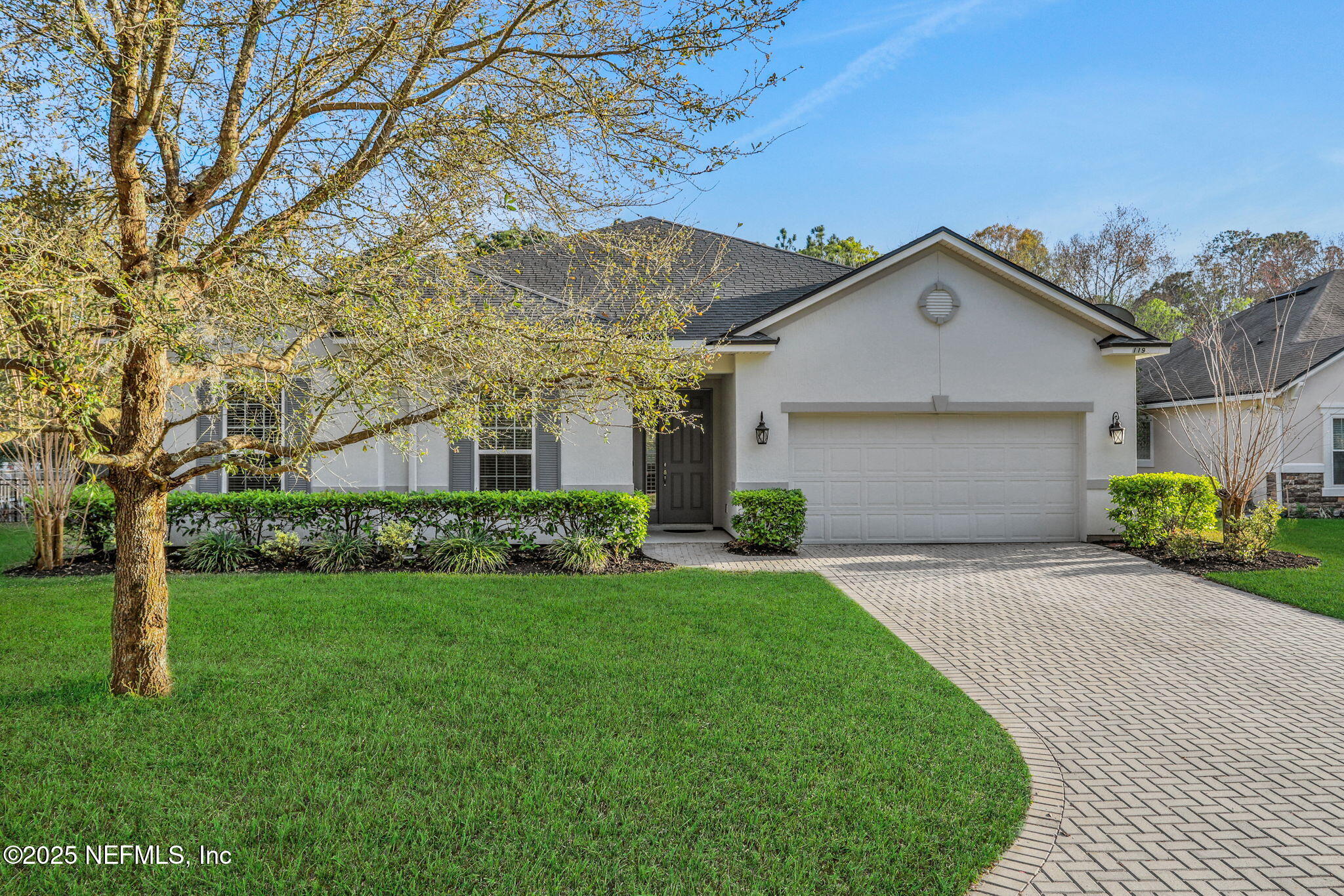119 Duck Pond Drive St. Augustine, FL 32086 - Photo 51 of 56 a front view of a house with a yard and garage
