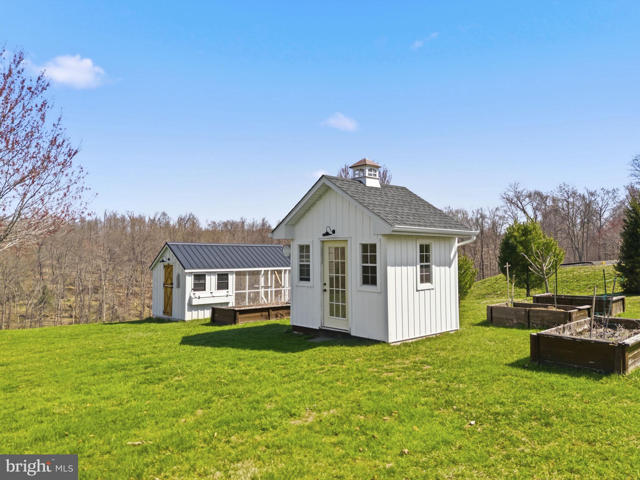 1100 Walters Mill Road Forest Hill, MD 21050 - Photo 11 of 18 a front view of a house with a garden and yard