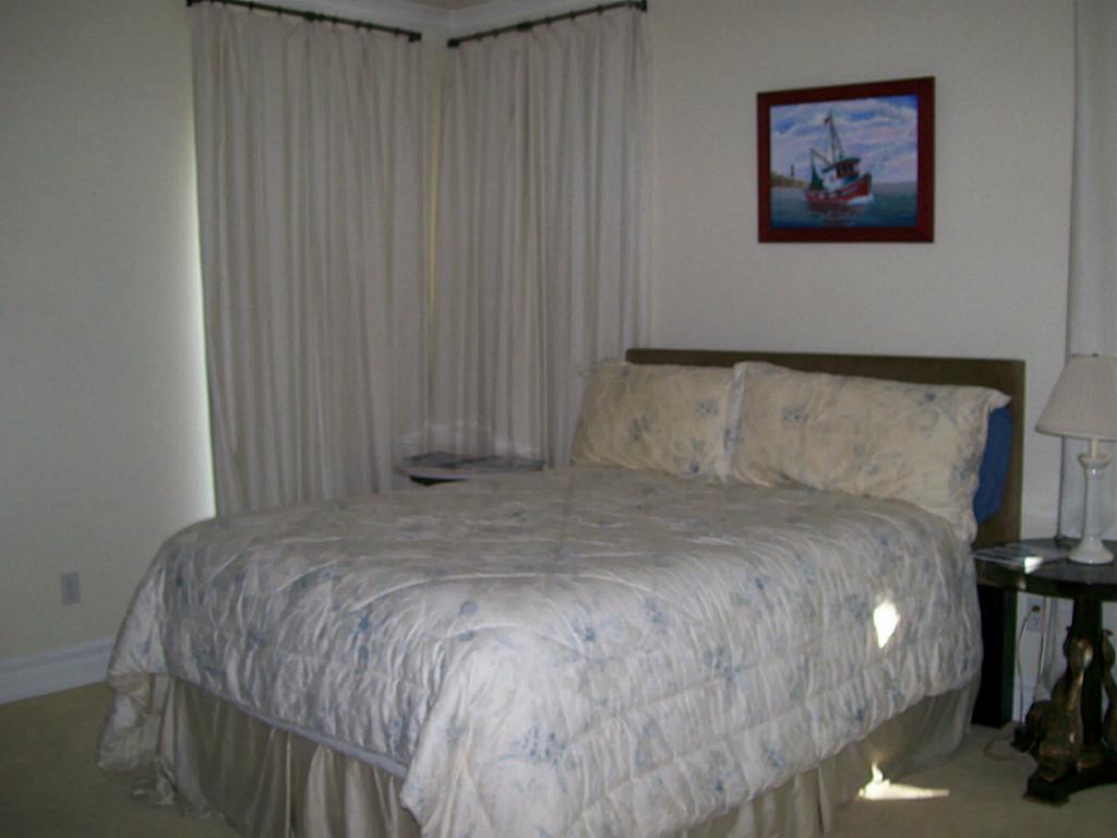 620 8th Street Kemah, TX 77565 - Photo 11 of 17 a bedroom with a bed and a painting on the wall