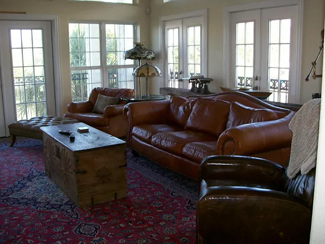 a living room with furniture and a floor to ceiling window