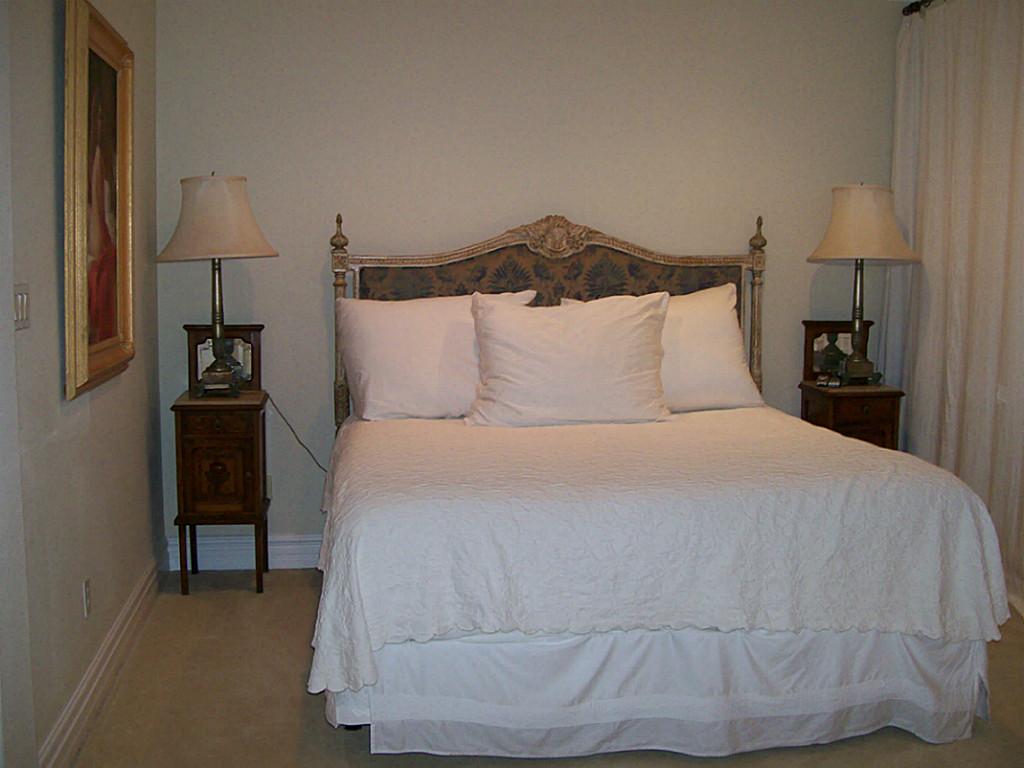 620 8th Street Kemah, TX 77565 - Photo 10 of 17 a large bed sitting in a bedroom and lamp