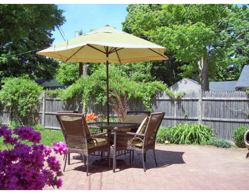 9 Pilgrim Road Hamilton, MA 01982 - Photo 5 of 26 a patio with a patio table and chairs