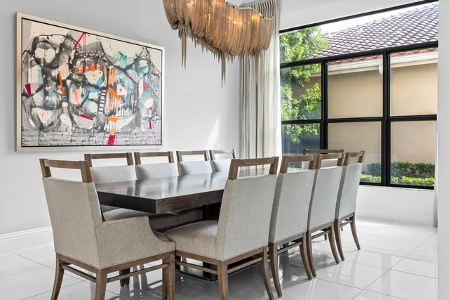 a view of a swimming pool with potted plants and palm trees