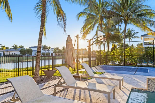 an aerial view of a house with garden space and a swimming pool