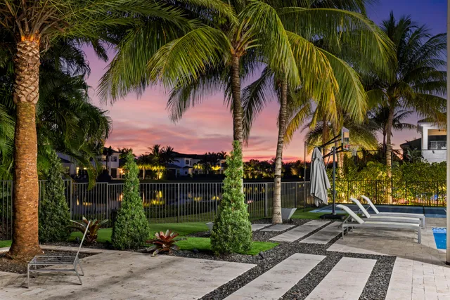 an aerial view of residential houses with outdoor space and trees