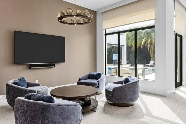 a view of a dining room with furniture and chandelier