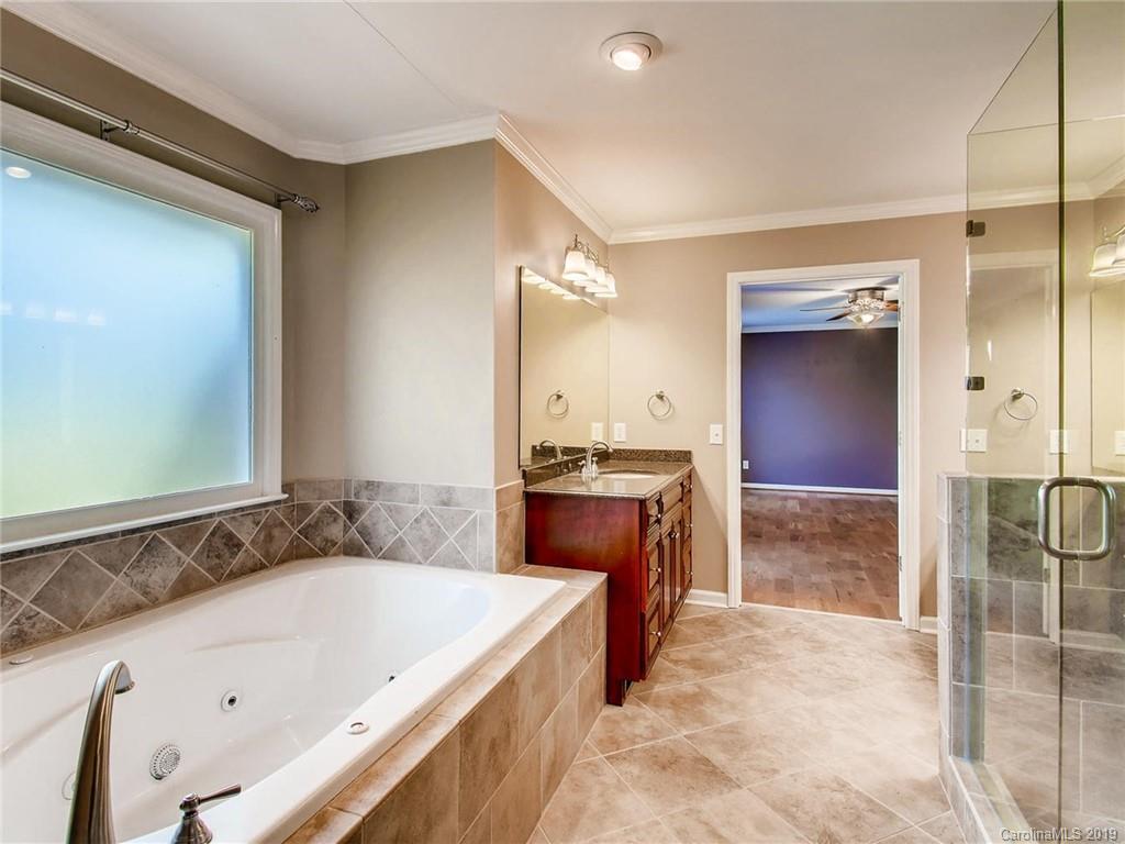 2484 Holbrook Road Fort Mill, SC 29715 - Photo 22 of 36 a bathroom with a granite countertop tub sink and mirror