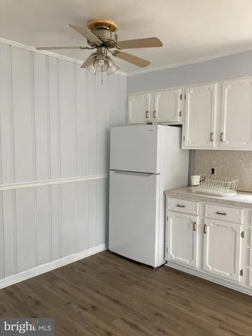a kitchen with stainless steel appliances a stove a sink and white cabinets