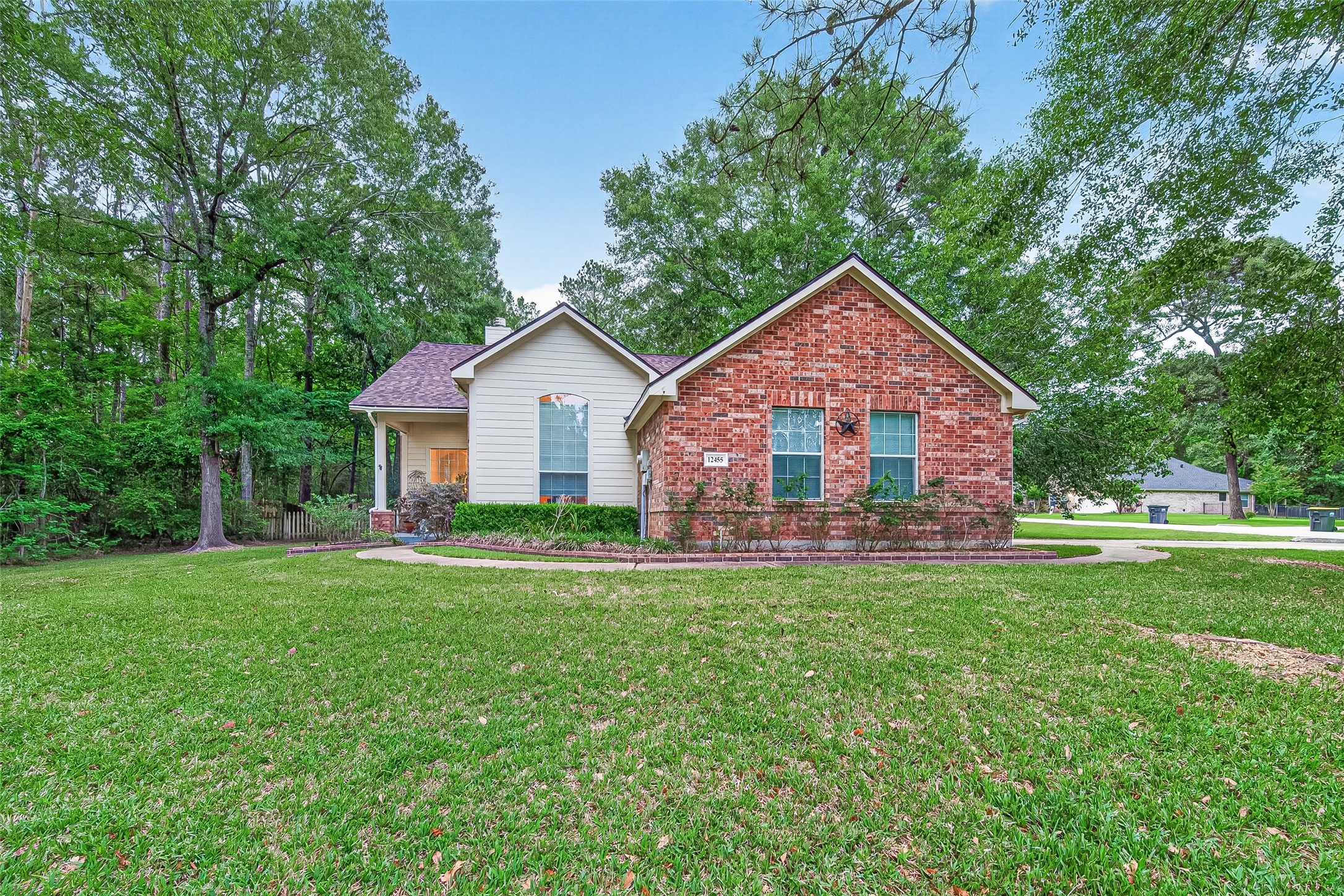 12455 West Summerlin Conroe, TX 77302 - Photo 2 of 31 a front view of a house with a yard and trees