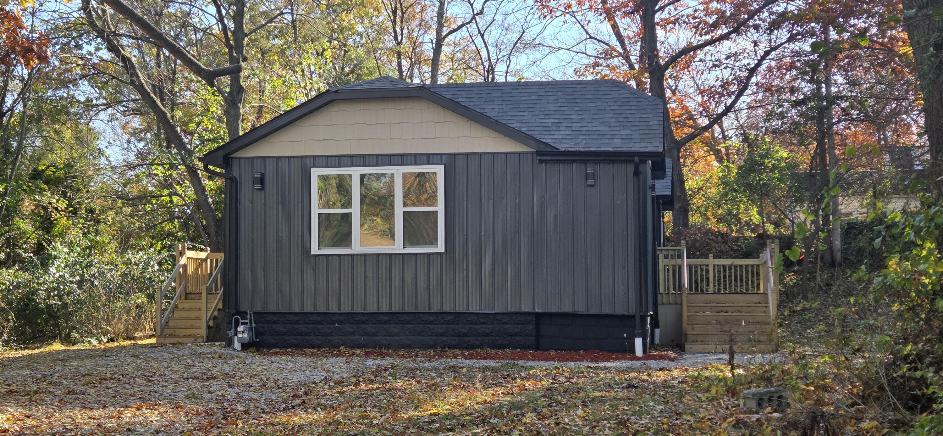 7325 Locust Avenue Gary, IN 46403 - Photo 115 of 136 a view of wooden house with large trees and wooden fence
