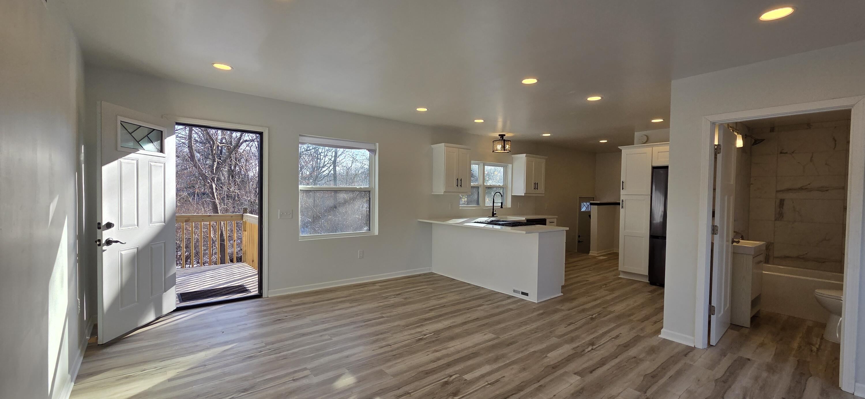 7325 Locust Avenue Gary, IN 46403 - Photo 16 of 136 a view of an empty room with wooden floor and a window