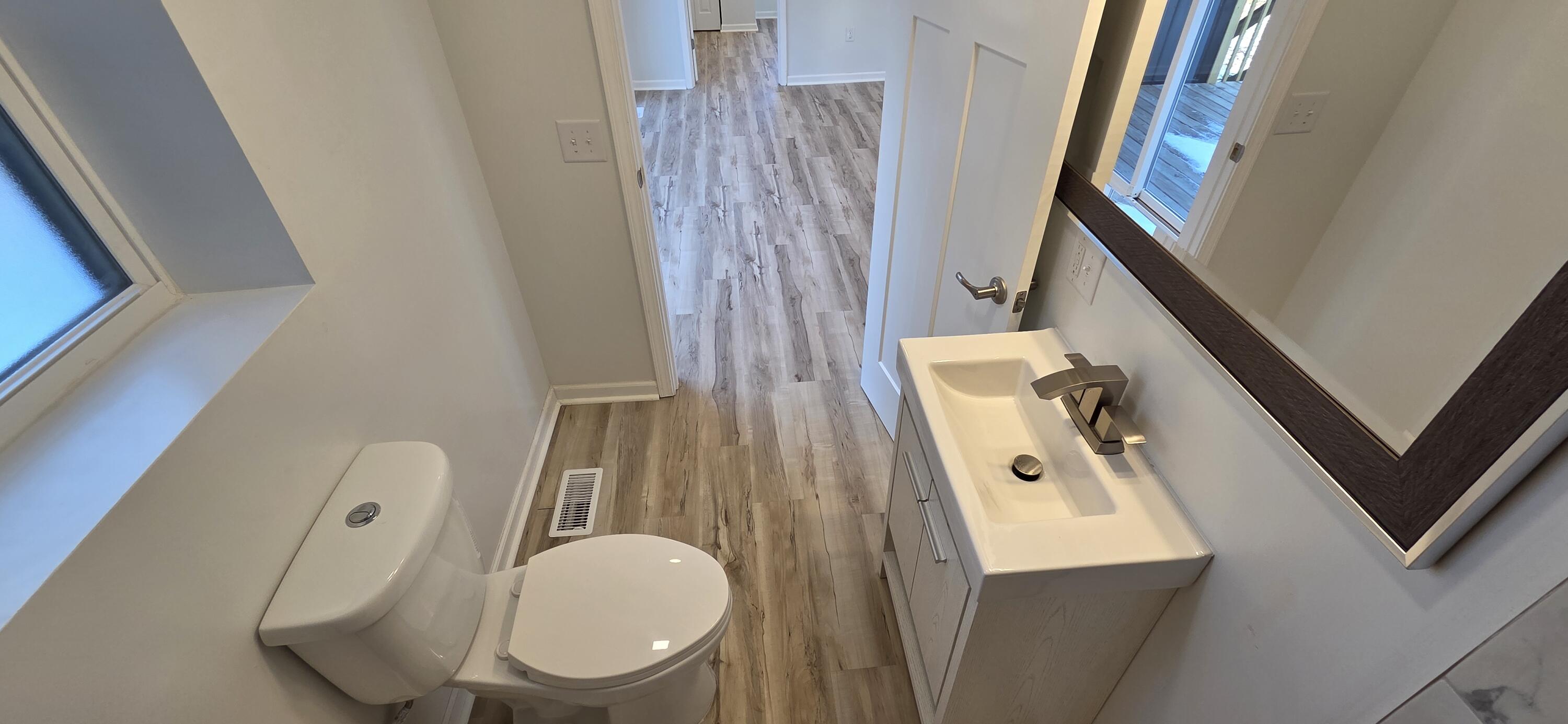 7325 Locust Avenue Gary, IN 46403 - Photo 45 of 136 a bathroom with a toilet a sink and a mirror