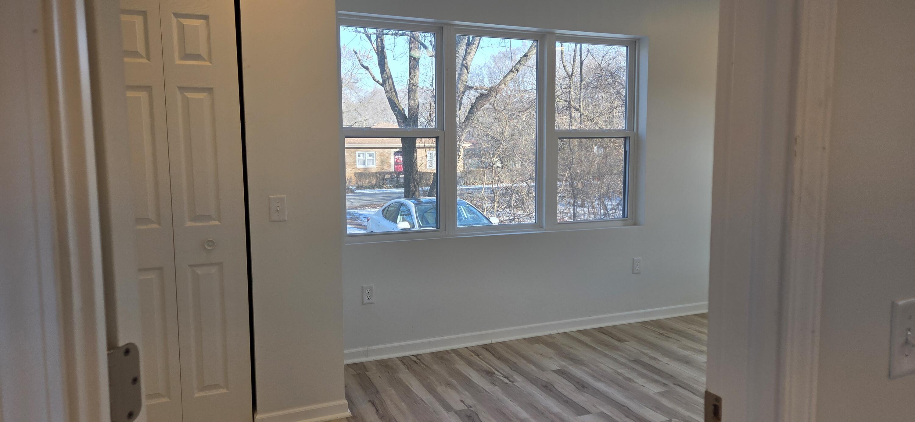 7325 Locust Avenue Gary, IN 46403 - Photo 52 of 136 a view of an empty room with wooden floor and a window