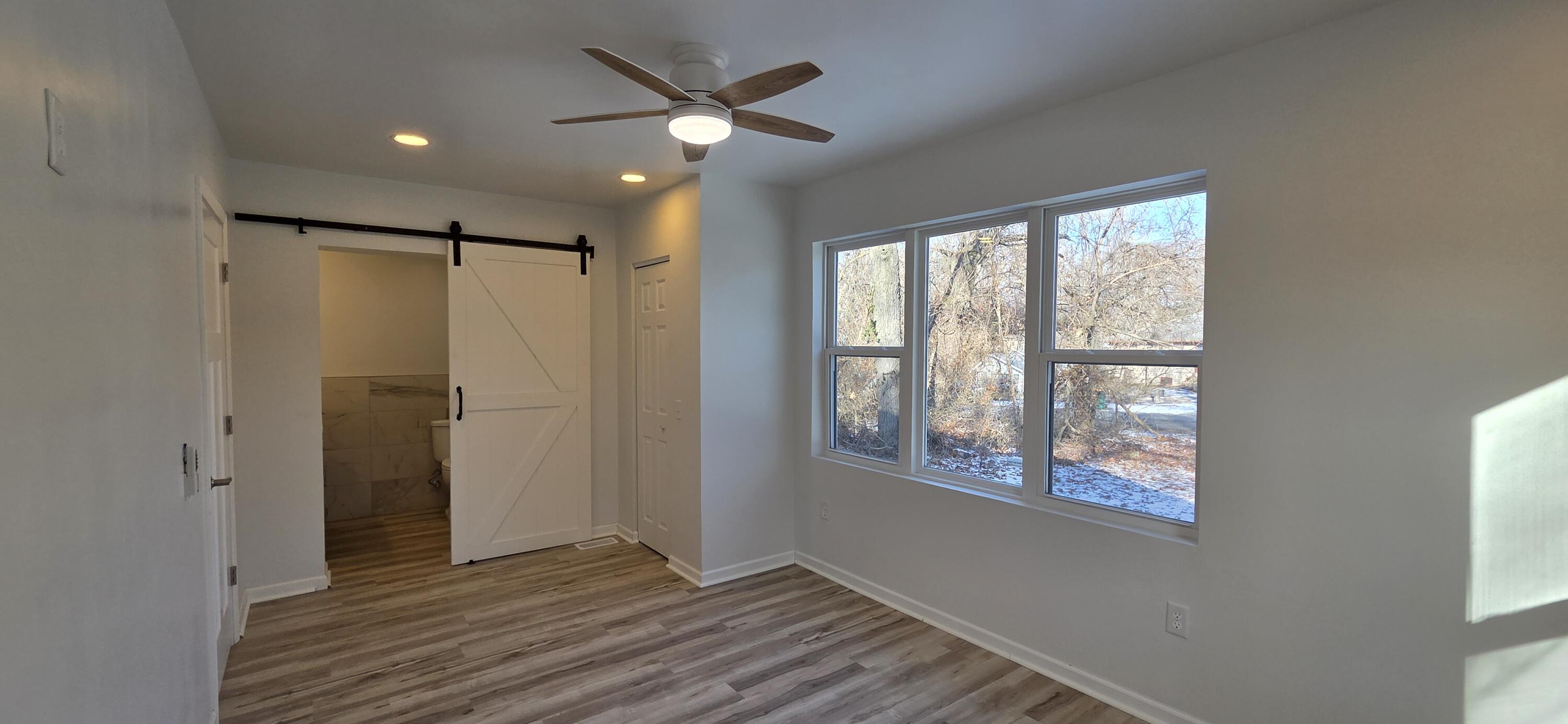 7325 Locust Avenue Gary, IN 46403 - Photo 55 of 136 a view of an empty room with a window and wooden floor