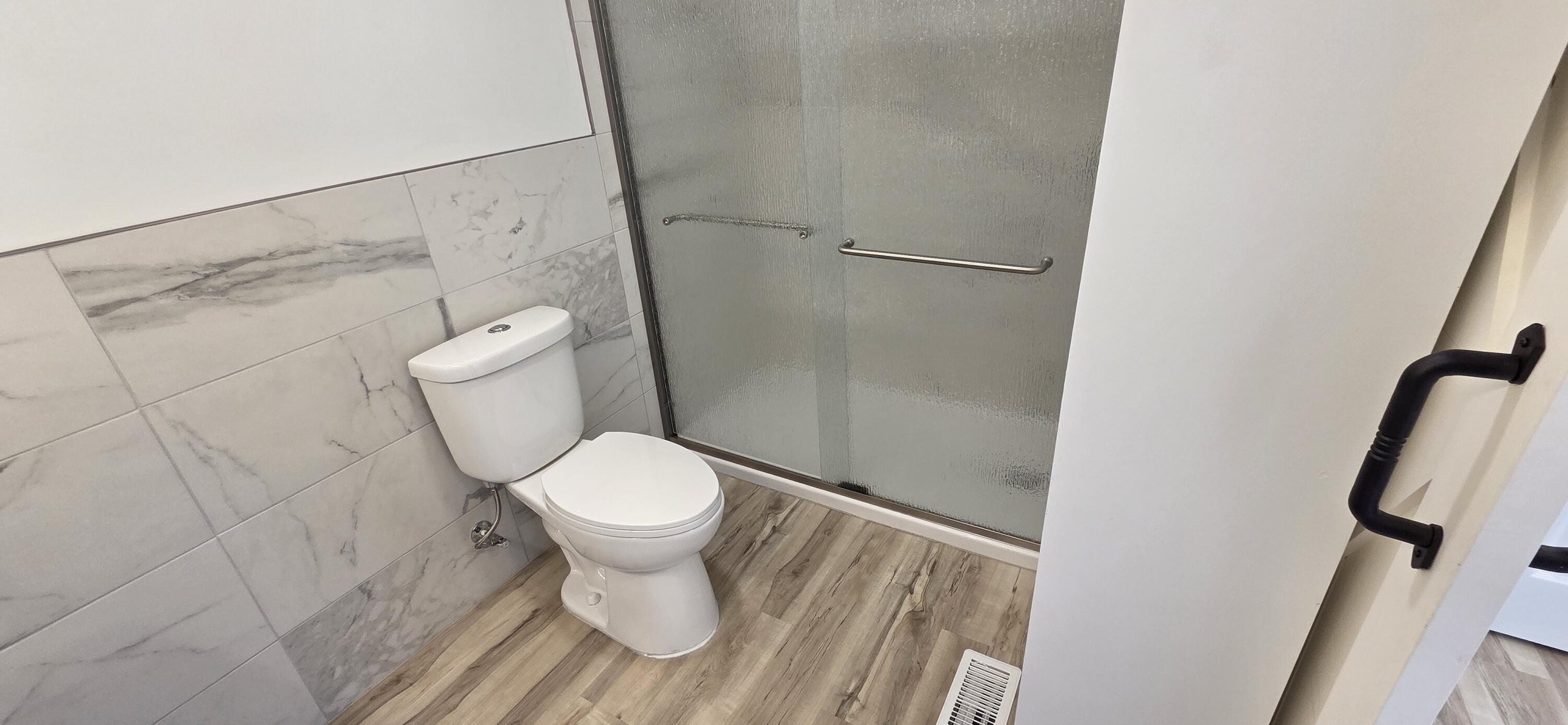 7325 Locust Avenue Gary, IN 46403 - Photo 58 of 136 a white toilet sitting next to a bathroom sink