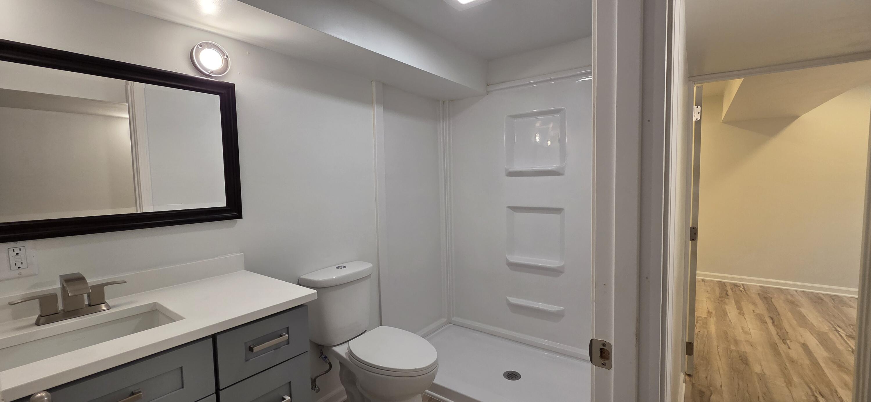 7325 Locust Avenue Gary, IN 46403 - Photo 95 of 136 a bathroom with a toilet a sink a mirror a vanity and shower