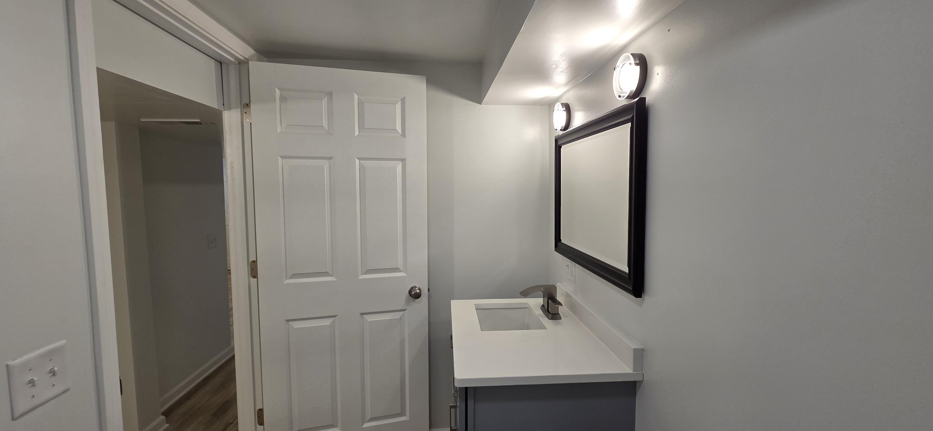 7325 Locust Avenue Gary, IN 46403 - Photo 99 of 136 a bathroom with a sink a mirror and shower
