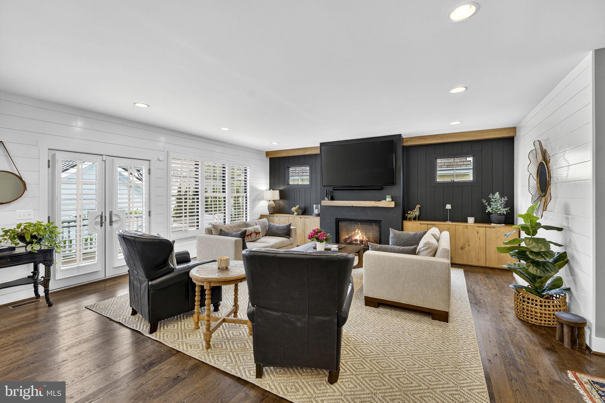 105 Reed Street Middleburg, VA 20117 - Photo 25 of 62 a living room with furniture a flat screen tv and a large window