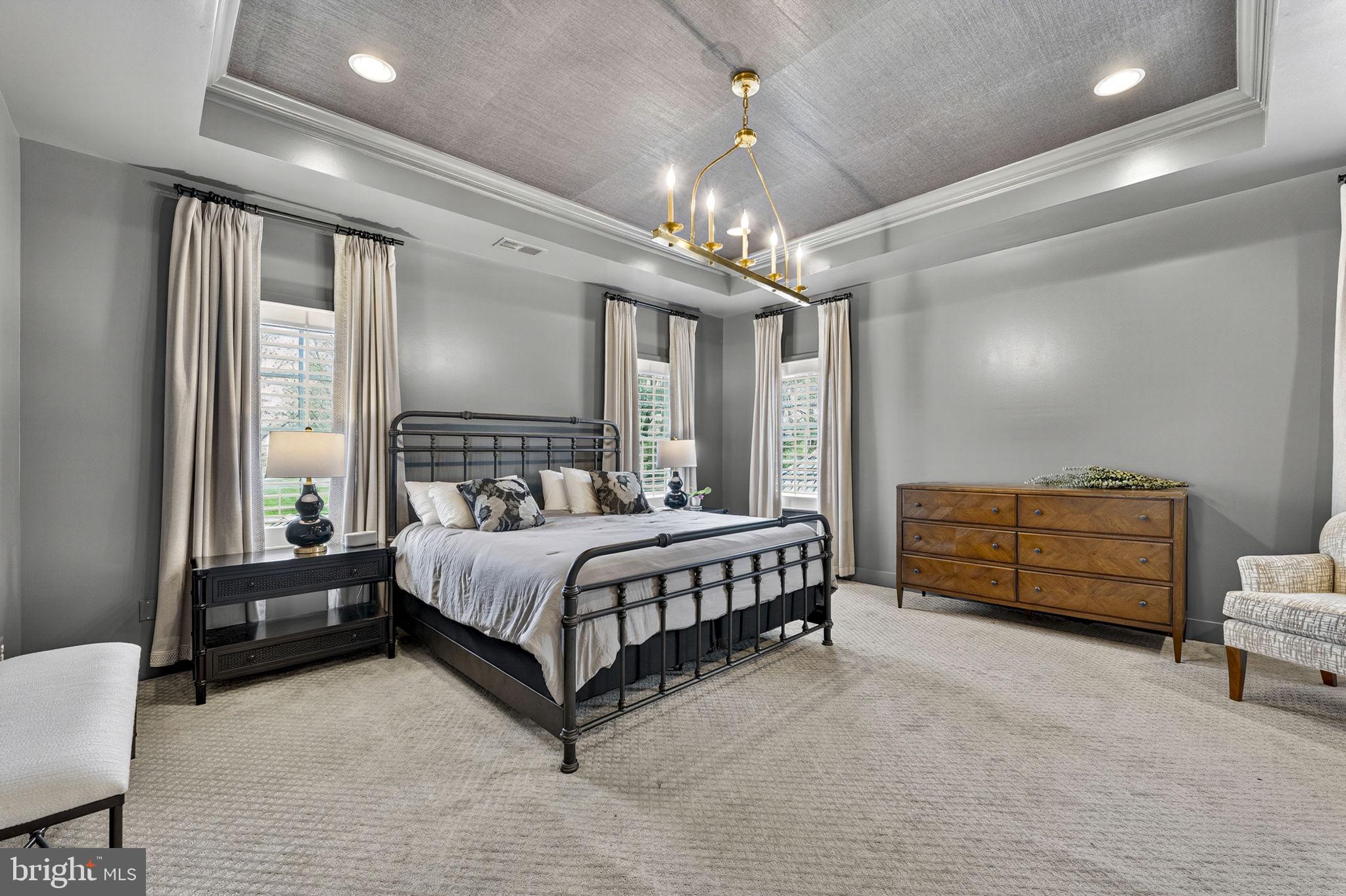 105 Reed Street Middleburg, VA 20117 - Photo 33 of 62 a bedroom with a bed and a chandelier