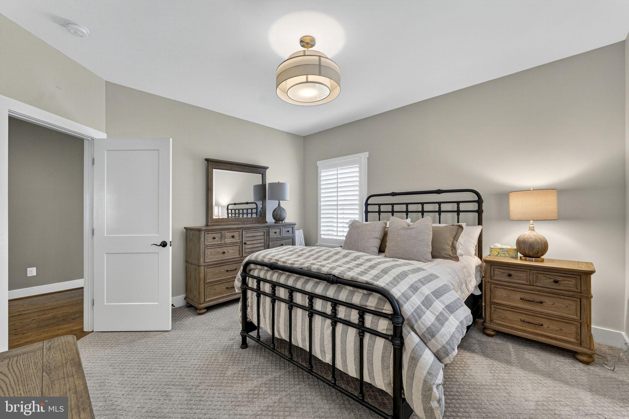 105 Reed Street Middleburg, VA 20117 - Photo 43 of 62 a bedroom with a bed and a lamp on table