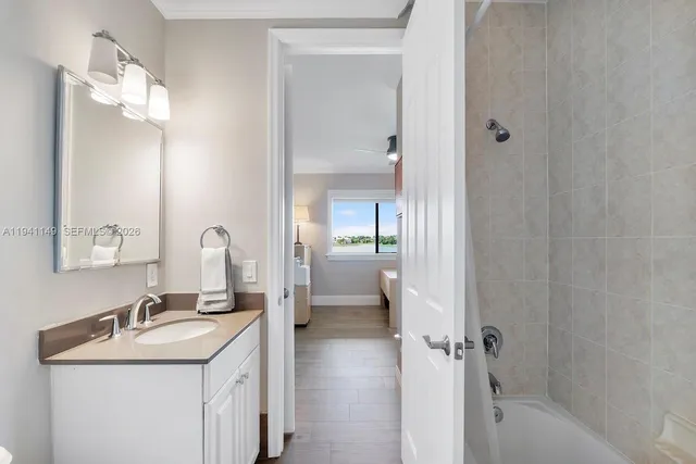 a bathroom with a double vanity sink toilet and a bathtub