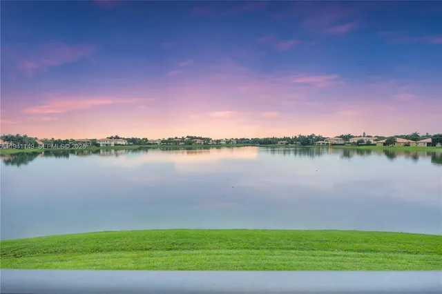an aerial view of residential houses with outdoor space and river