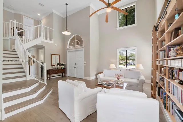 an aerial view of ocean and residential houses with outdoor space
