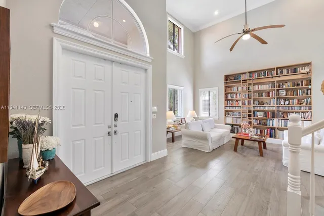 a living room with furniture and a book shelf