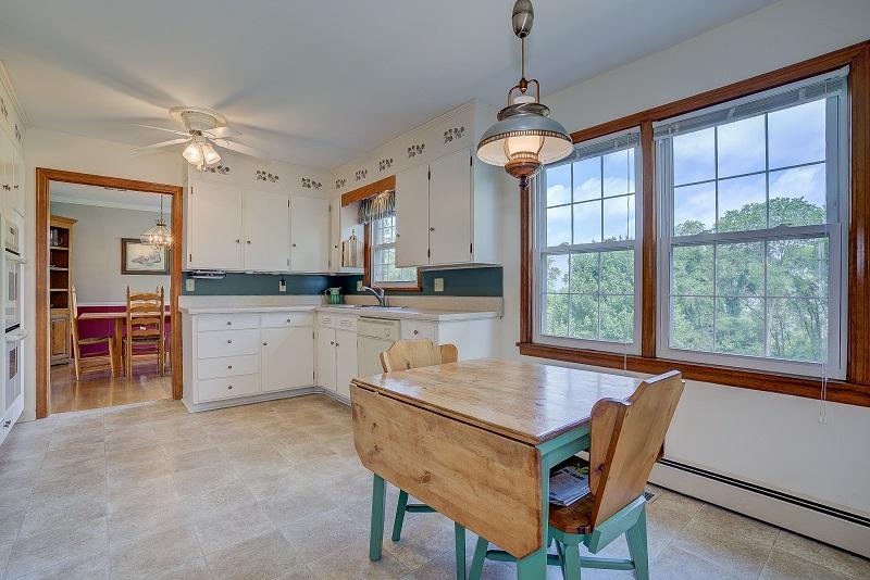 627 Olney Road Vinton, VA 24179 - Photo 15 of 43 a dining room with wooden floor a chandelier a wooden table and chairs