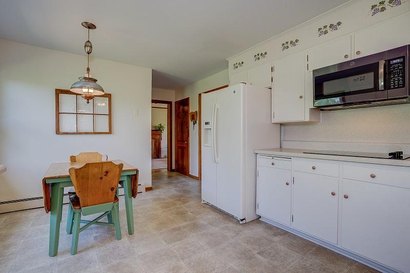 627 Olney Road Vinton, VA 24179 - Photo 18 of 43 a kitchen with stainless steel appliances granite countertop a refrigerator a stove a microwave oven a sink dishwasher and a dining table with wooden floor
