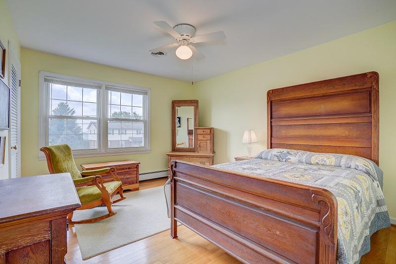 627 Olney Road Vinton, VA 24179 - Photo 30 of 43 a bedroom with a bed and a chandelier