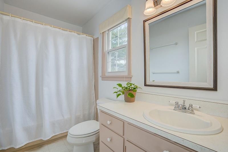 627 Olney Road Vinton, VA 24179 - Photo 33 of 43 a bathroom with a granite countertop sink a toilet and a mirror